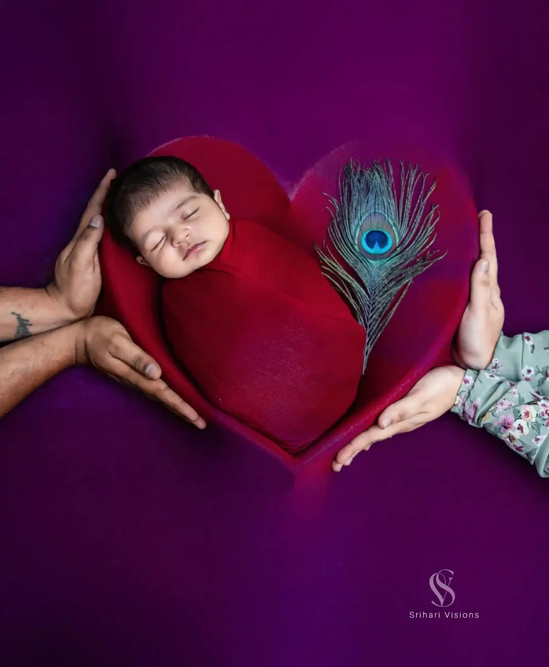Parents holding their newborn baby during photoshoot