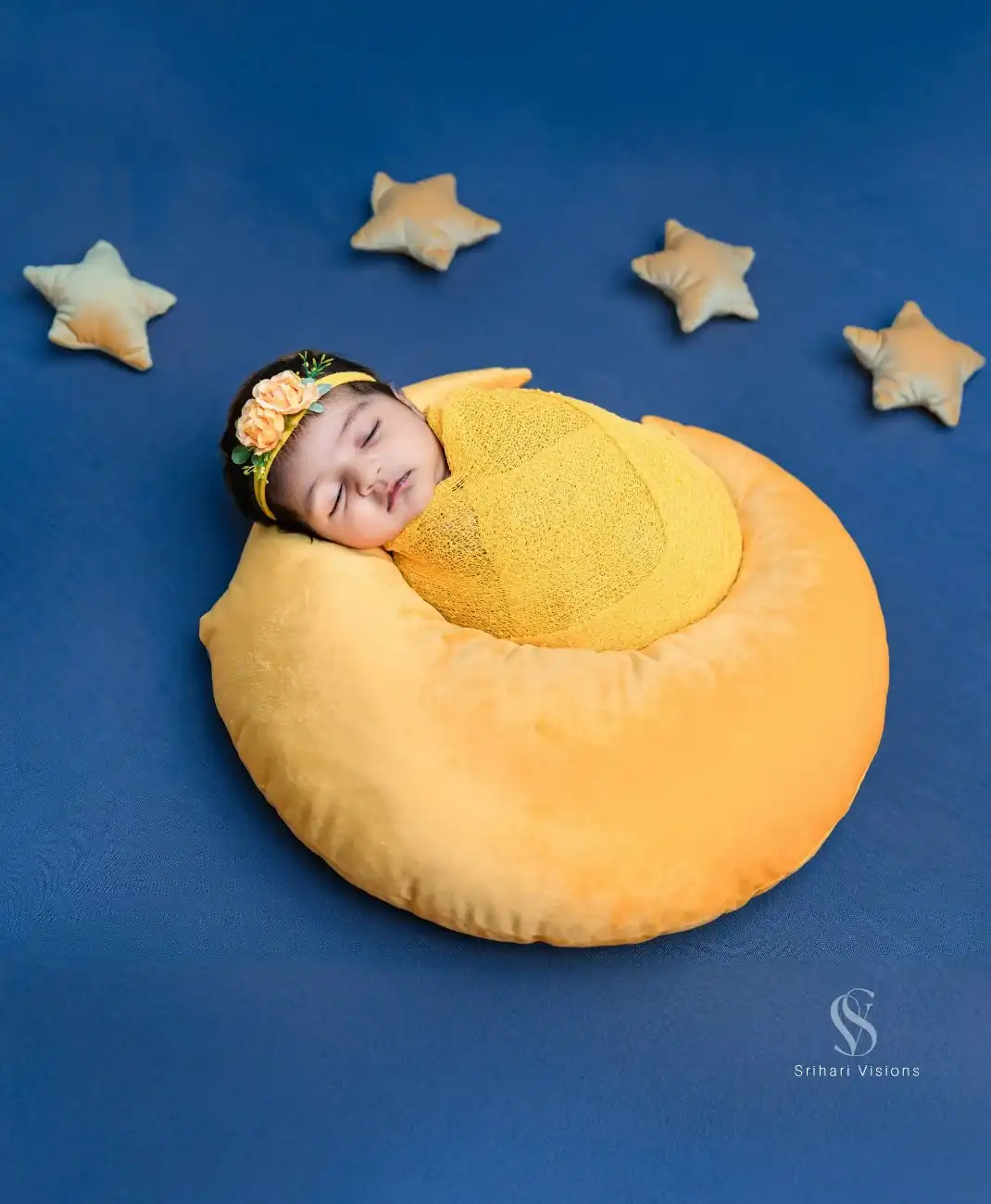 Adorable newborn photography setup with soft cushions