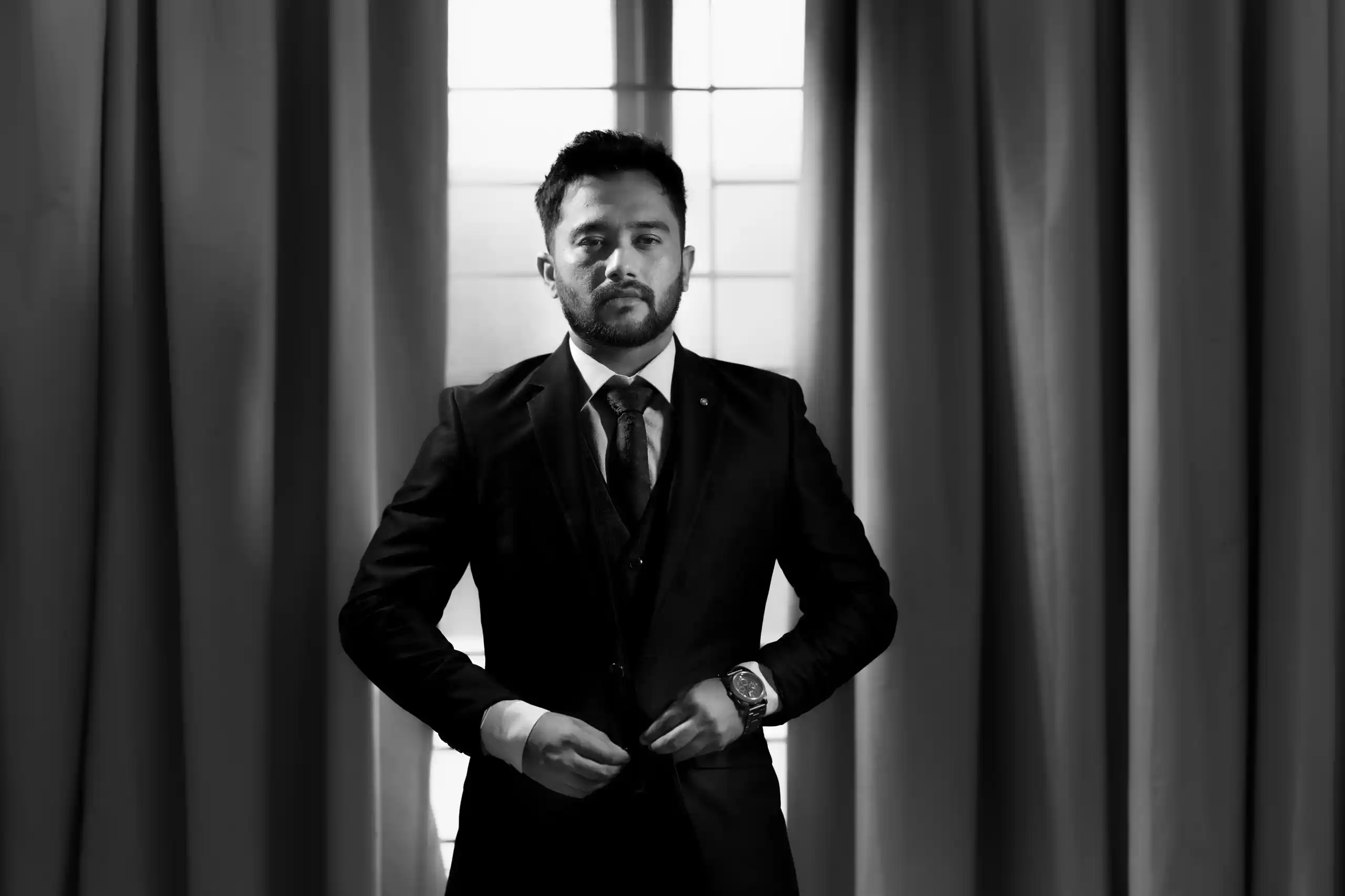 Groom looking at camera during engagement photoshoot