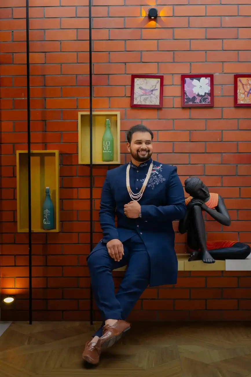 Groom smiling in traditional engagement attire