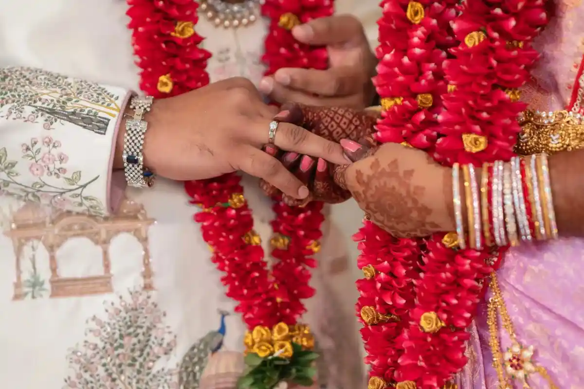 Close-up engagement photography of couple's ring exchange