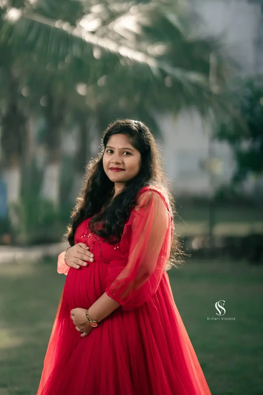 Expecting mother highlighting her baby bump during maternity session