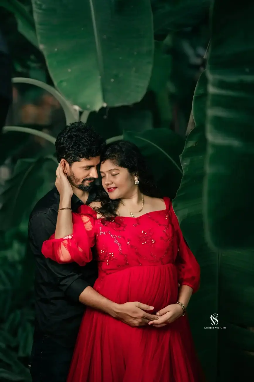 Expecting parents smiling together during maternity photography