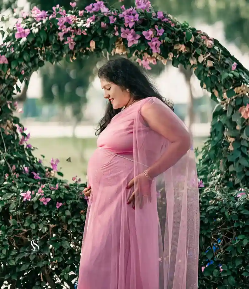 Traditional Indian maternity portrait with floral decorations