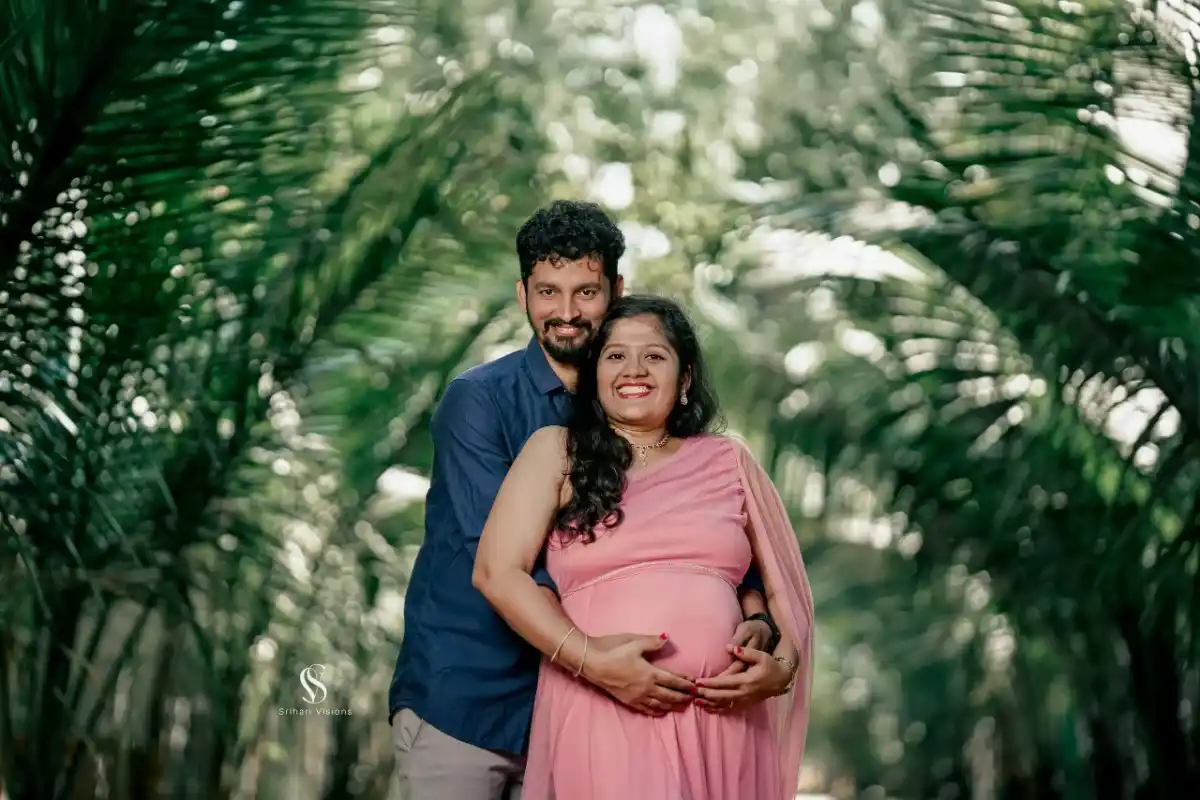 Husband holding pregnant wife's baby bump during maternity photography