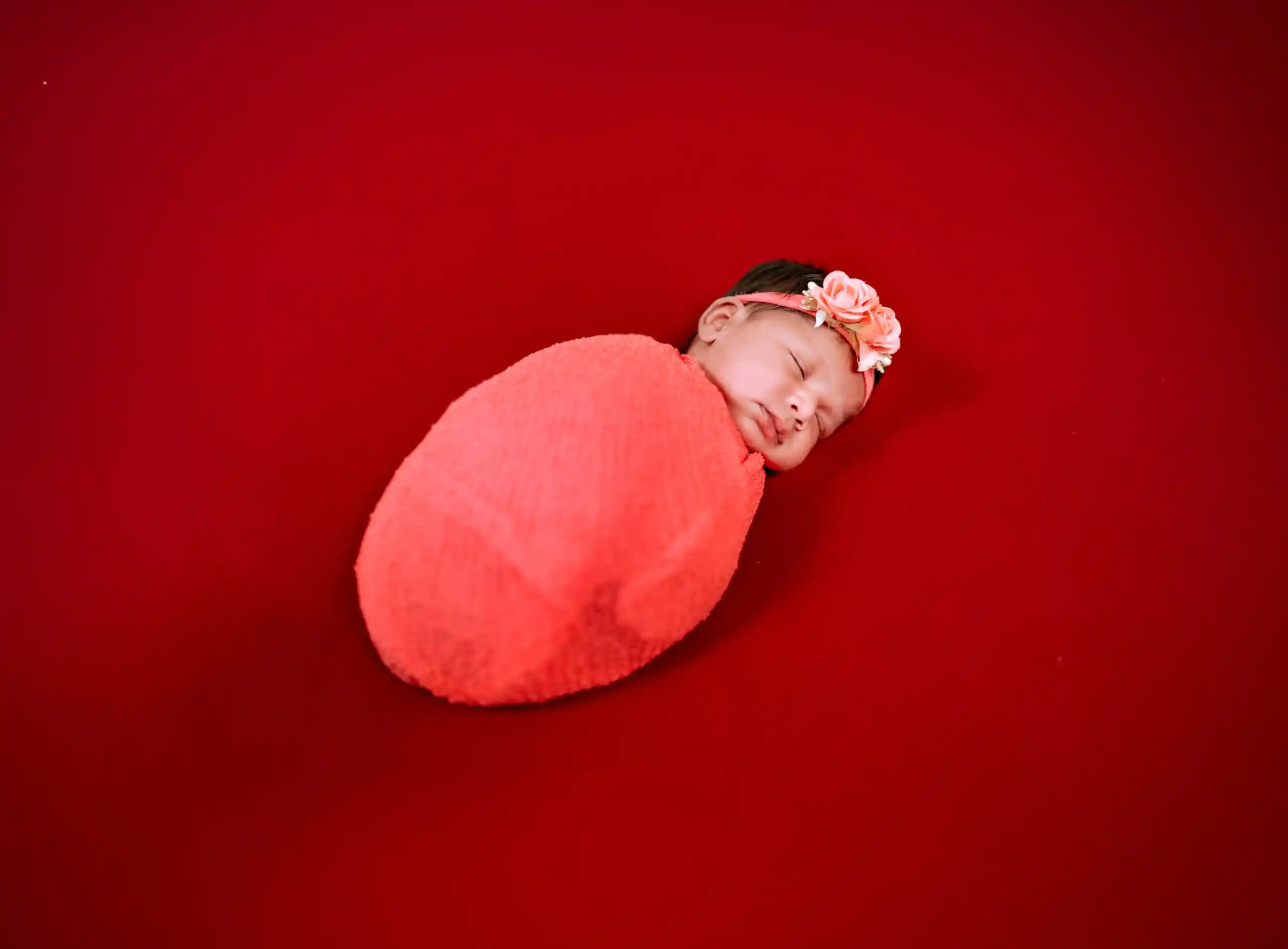 Baby sleeping peacefully in a creative newborn photography setup
