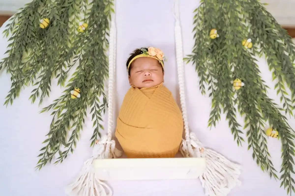 Adorable newborn baby in a creative photography setup