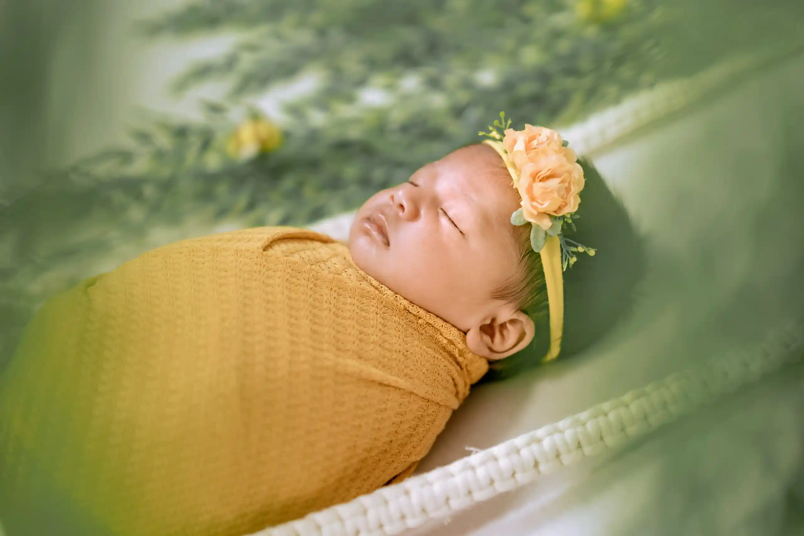 Newborn baby photoshoot with soft floral decorations