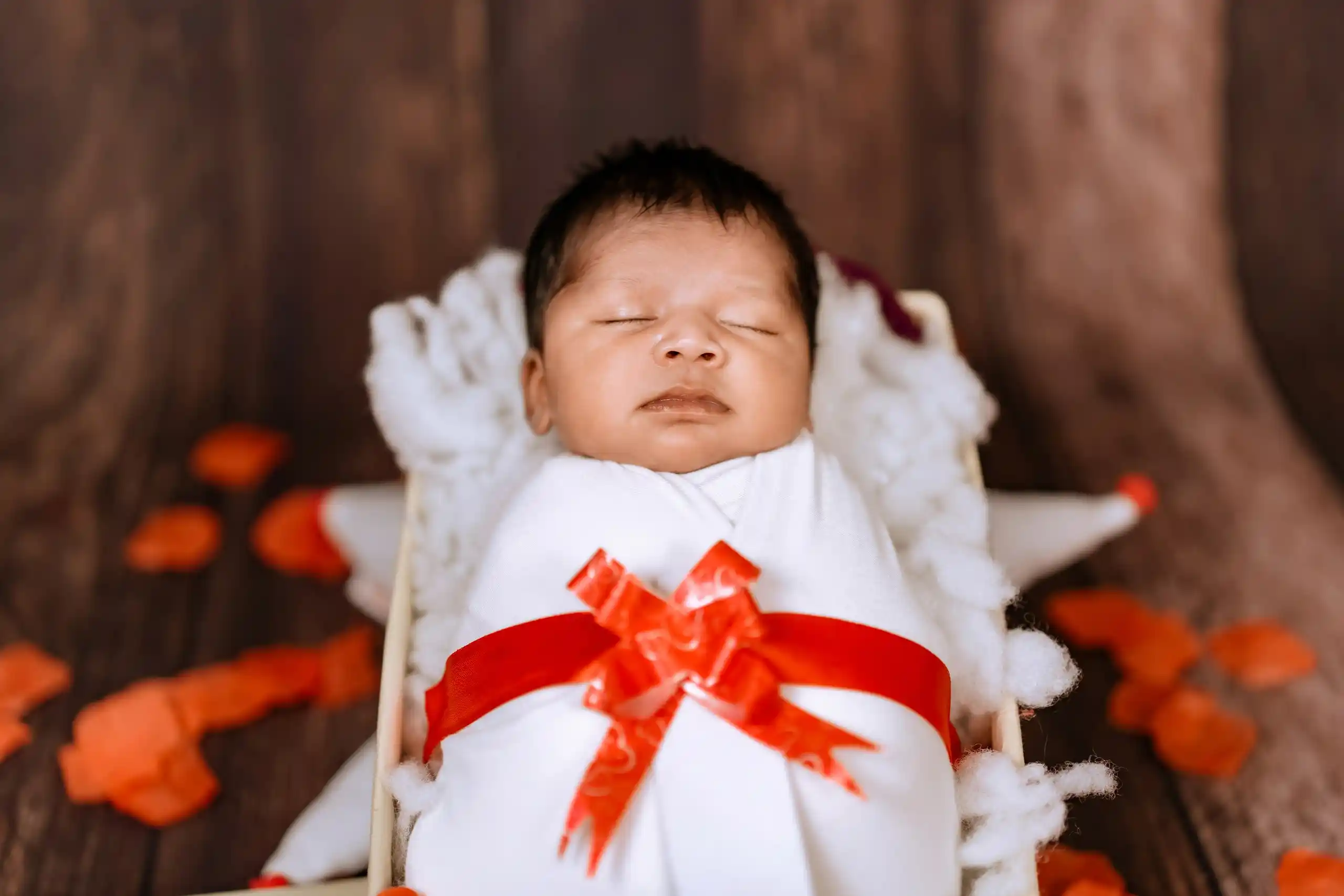Adorable sleeping newborn wrapped in a soft blanket